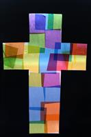 Colourful cross made from overlapping translucent squares on a black background.